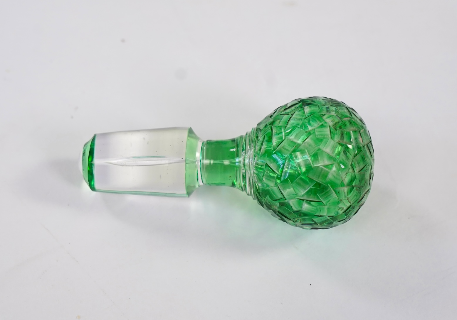 Attributed to Stevens and Williams of Stourbridge, a green flashed and cut pinched glass decanter